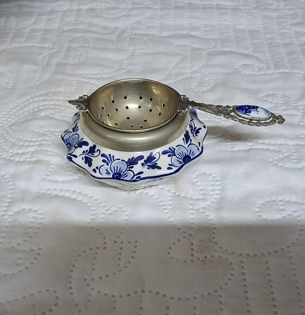Tea Strainer - delfts blue and white bowl with silver plate strainer.  Ceramic windmill on the handle.