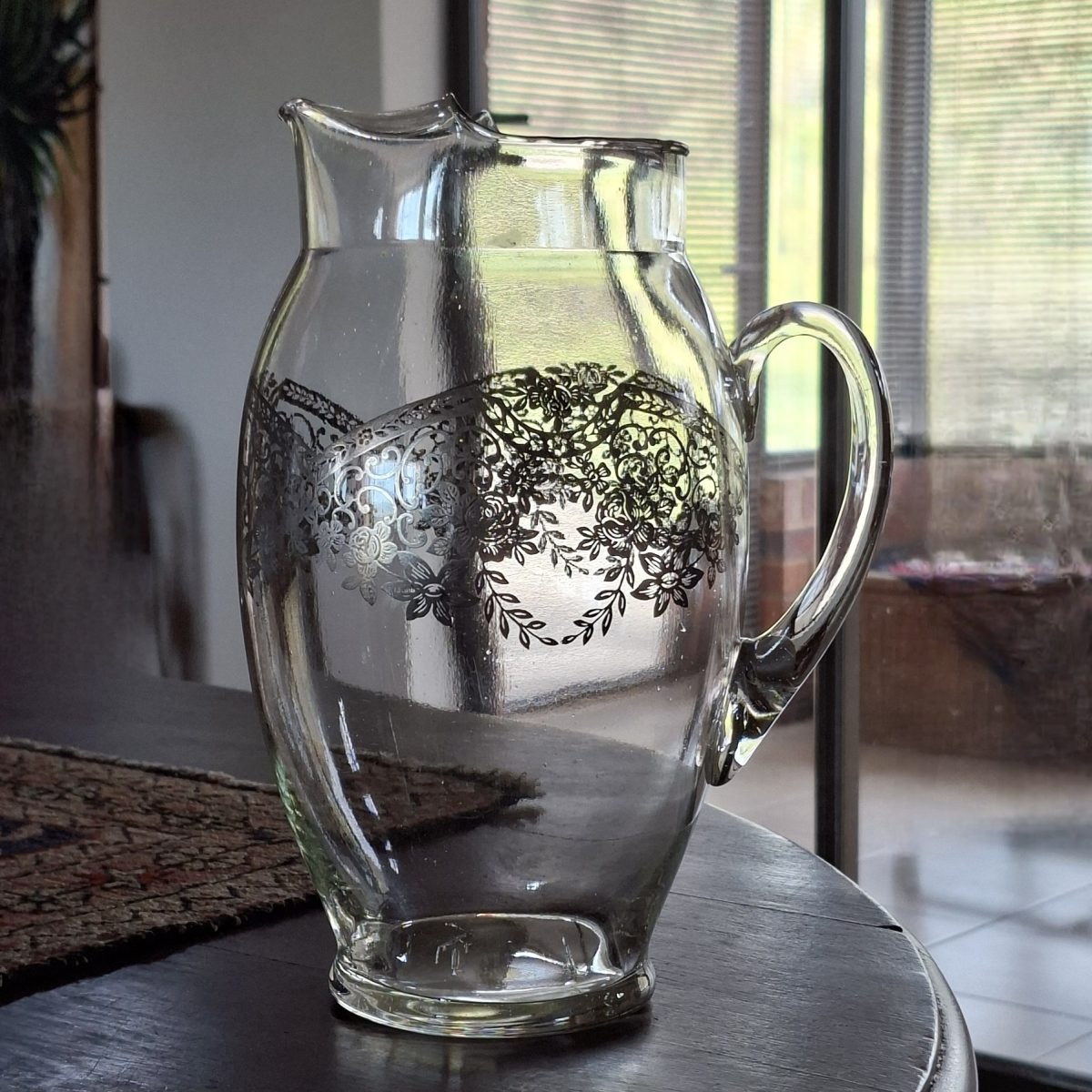 Lg water jug with silver filigree embossed onto the jug.  Perfect Wedding table water or punch jug.