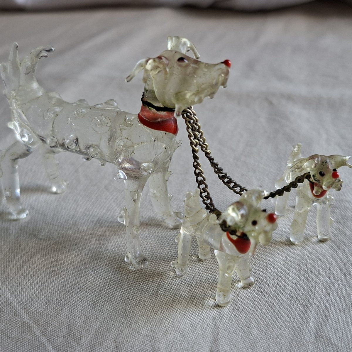 Glass dog and 2 pups red collars and noses.   Vintage scruffy dog