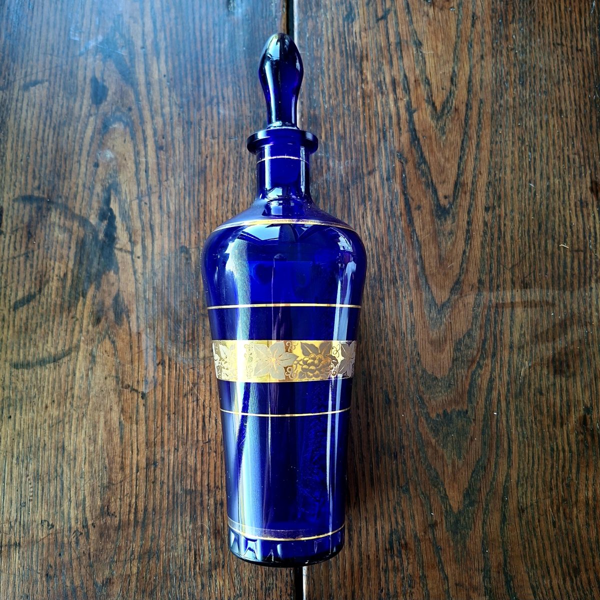 Glass bottle Decanter Cobalt Blue with gold grape vine design -28 cms tall - italian?