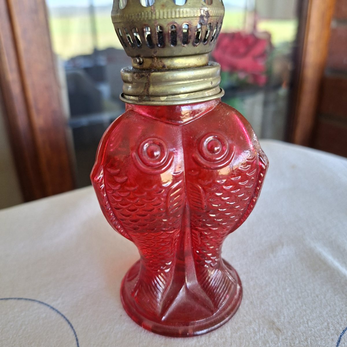 Oil lamp - red glass fishes - fluted glass chimney.  18 sms tall