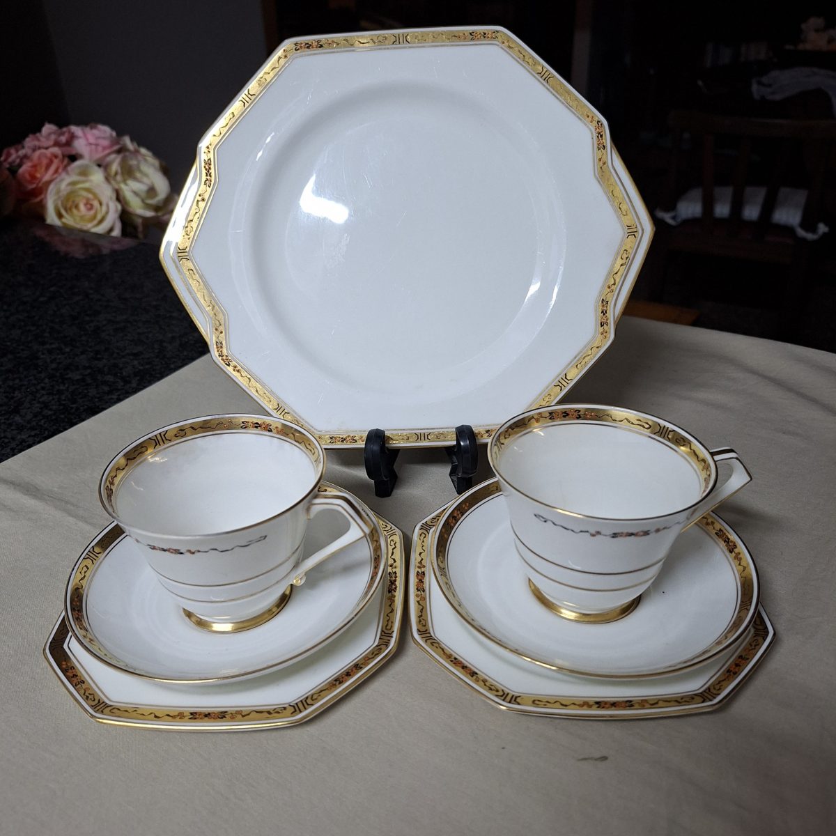 Two Paragon tea trios with a cake plate - gold and white with fine design