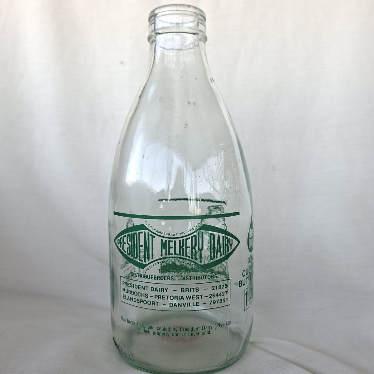 Milk bottle - President Dairy 1 Lit Cultured Buttermilk bottle - English and Afrikaans