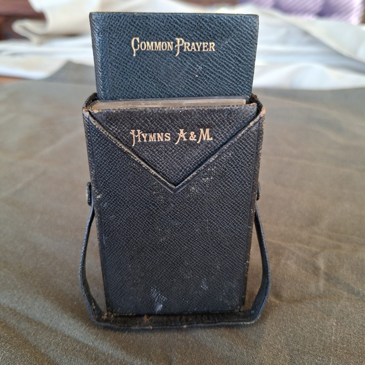Christian Holy Hymn book and Common praybook in a leather sleeve