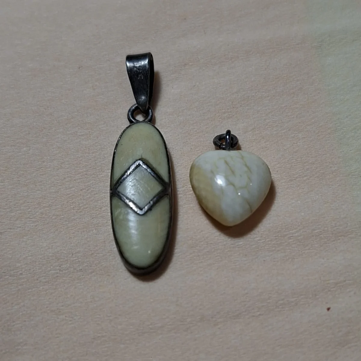 Silver and bone pendant together with a heart pendant