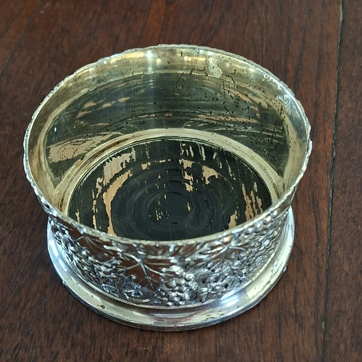 Plated wine bottle coaster with wooden base