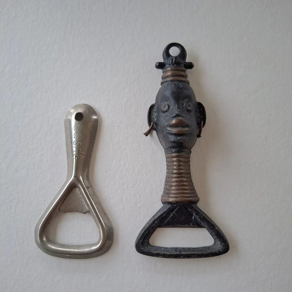 Two bottle openers "Castle" and metal "african queen"